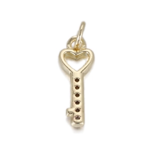 Detailed close-up of golden heart-shaped key pendant with openwork design and top ring