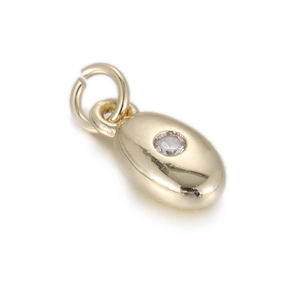 Detailed view of an oval gold-plated pendant with a sparkling round zircon stone inlay