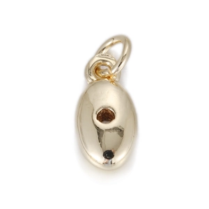 Macro detail of oval gold pendant with smooth mirror finish and circular cutout