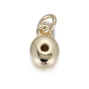 Detailed macro view of a polished golden donut-shaped mini pendant for DIY jewelry