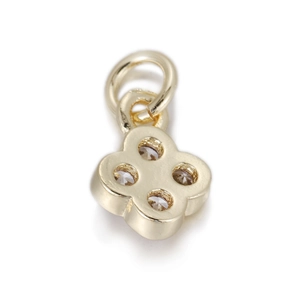 Detail of a gold clover pendant with four clear zircons and polished finish
