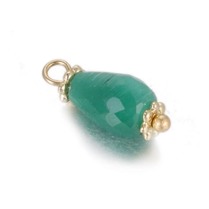 Detail of emerald green faceted stone pendant with gold floral caps and top ring