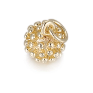 Detailed view of a golden sphere charm with elegant beaded relief and high-polish finish
