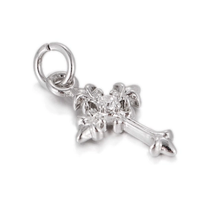 Macro shot of silver gothic cross pendant with fleur-de-lis edges and center crystal