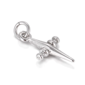 Detailed macro view of a polished silver cross pendant with beaded decorative crossbar