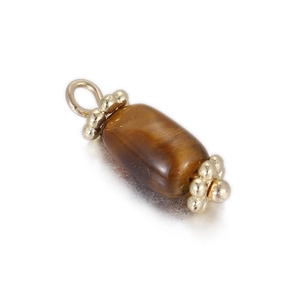 Macro view of cylinder tiger eye stone pendant with golden flower caps and ring clasp