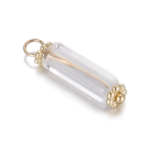 Macro view of geometric resin pendant with gold metal core and petal cap details