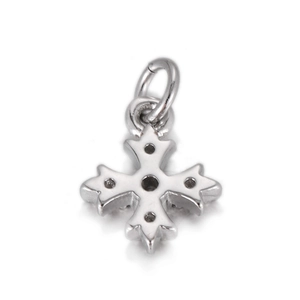 Macro shot of silver Maltese cross pendant with cutout details and polished finish