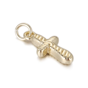 Detail of 14k gold plated cross-shaped baguette pendant with textured metal surface