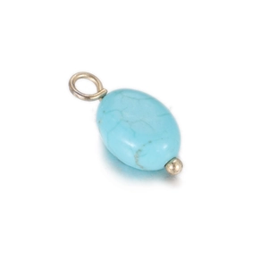 Macro detail of oval turquoise pendant with natural mineral veins and silver metal bail