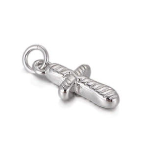 Macro shot of silver baguette-textured cross pendant with closed ring clasp