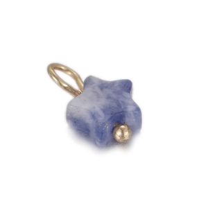 Detailed view of a star-shaped blue sodalite stone pendant with a golden metal loop charm