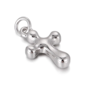 Macro detail of polished silver cross pendant with rounded ends and smooth metallic finish