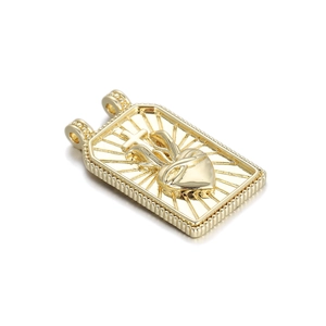 Golden Sacred Heart pendant with cross and sunburst rays in a rectangular embossed design