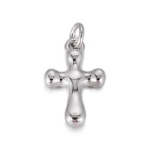Macro view of polished silver cross pendant featuring smooth liquid metal texture and round edges