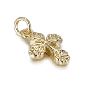 Close-up of golden cross pendant featuring embossed leaf textures and a polished finish