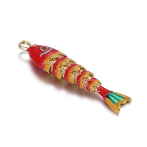 Detailed view of fish-shaped enamel pendant with vibrant red head and orange scales