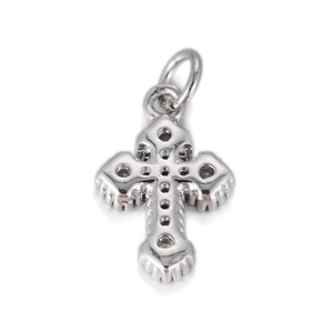 Detail of silver cross pendant back featuring intricate honeycomb hollowed metal patterns
