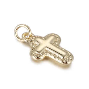 Detailed view of a gold-plated cross pendant with scalloped edges and polished finish