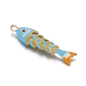 Detail of blue koi fish pendant with colorful enamel scales and a small red stone eye