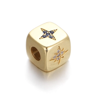 Detail of gold-plated star charm bead with blue and clear zircon for DIY jewelry