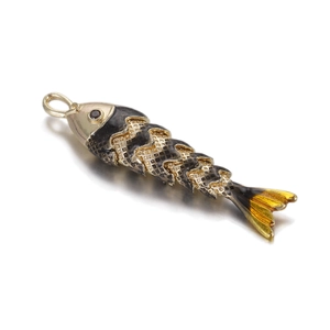 Macro detail of flexible articulated koi fish pendant with black enamel and gold frame
