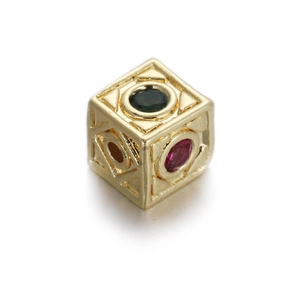 Macro detail of 14k gold plated cubic bead with green and pink zircon inlay