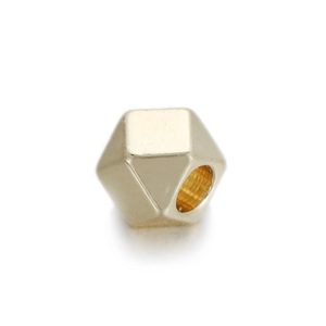 Detailed macro view of a 14k gold-plated geometric multifaceted spacer bead for DIY jewelry