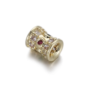 Macro shot of 14k gold plated cylindrical bead with inlaid colorful zirconia crystals