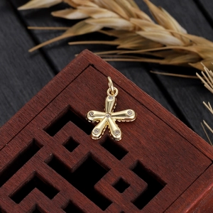 Mini gold-plated star pendant with cubic zirconia stones on vintage wood box