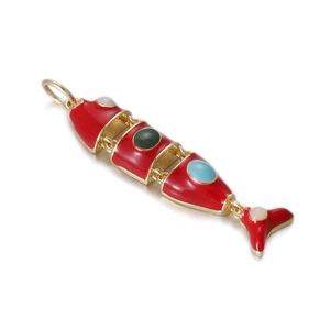 Macro detail of red enamel koi fish pendant with movable joints and inlaid gemstones