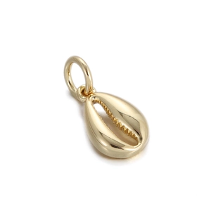 Detailed view of a gold shell pendant with polished surface and internal teeth design