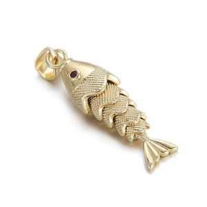 Detailed macro view of a golden articulated fish pendant with red gemstone eyes