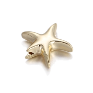 Macro detail of polished gold starfish pendant charm with realistic curved sea star arms
