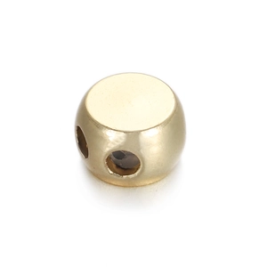 Macro view of gold 14k copper spacer bead with multi-hole design for DIY jewelry