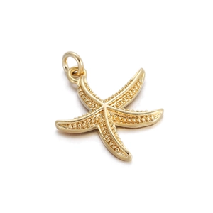 Macro detail of a golden starfish pendant with textured surface and top hanging loop