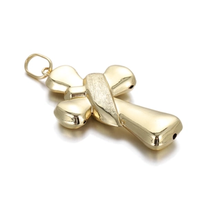 Detailed close-up of 14k gold plated copper cross bead with cross strap texture and bail