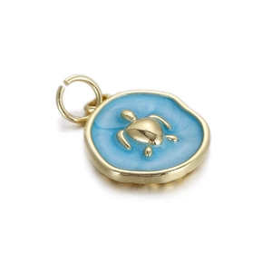 Detail view of a turtle pendant with blue enamel and gold-plated copper finish