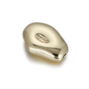 Detailed view of gold 14k bean-shaped metal spacer bead with high-polished mirror finish