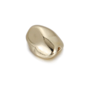 Close-up of polished 14k gold plated copper spacer bead for DIY jewelry making