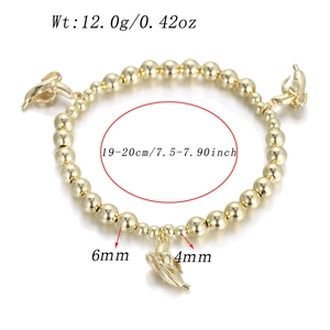 Detail of gold bead bracelet with banana pendants showing length and weight measurements