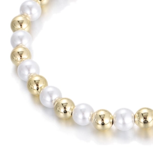 Detail of alternating white round pearls and gold mirror-finished copper beads on a bracelet