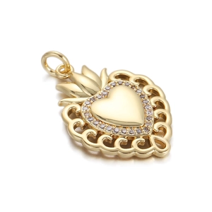 Detailed view of a golden sacred heart pendant with white zircon inlays and wave hollow design