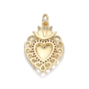 Detail of vintage gold heart pendant with intricate filigree texture and crown top