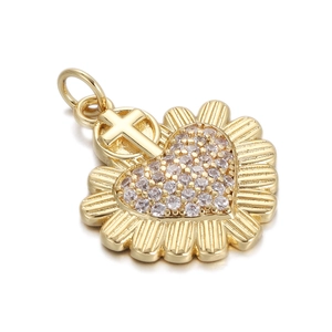 Detailed macro view of a gold heart pendant with cubic zirconia and religious cross