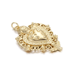 Detail of vintage gold heart pendant with baroque floral borders and angel relief