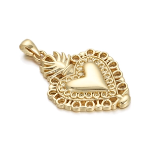 Detailed view of heart-shaped gold pendant with intricate lace edges and vintage carvings
