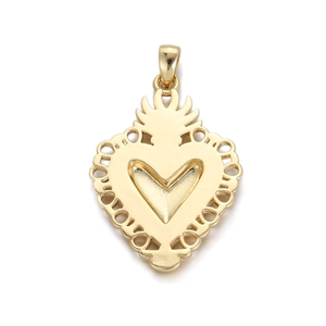 Detailed view of a gold Sacred Heart pendant with radiant flame and hollow edge detail