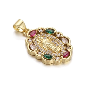 Macro view of gold-plated Virgin Mary pendant with colorful zircon stones and floral edge