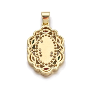 Detailed macro view of vintage gold-plated oval pendant with red and green gemstones